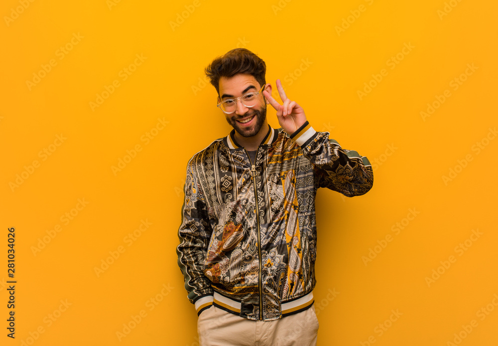 Young cool man fun and happy doing a gesture of victory Young cool man fun and happy doing a gesture of victory