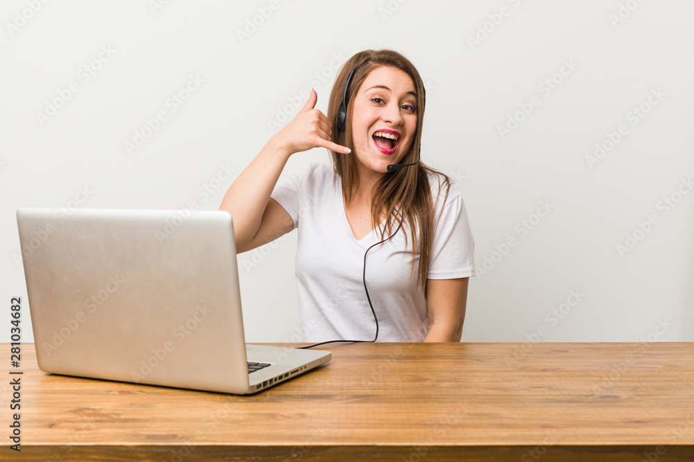 Young telemarketer woman showing a mobile phone call gesture with fingers.