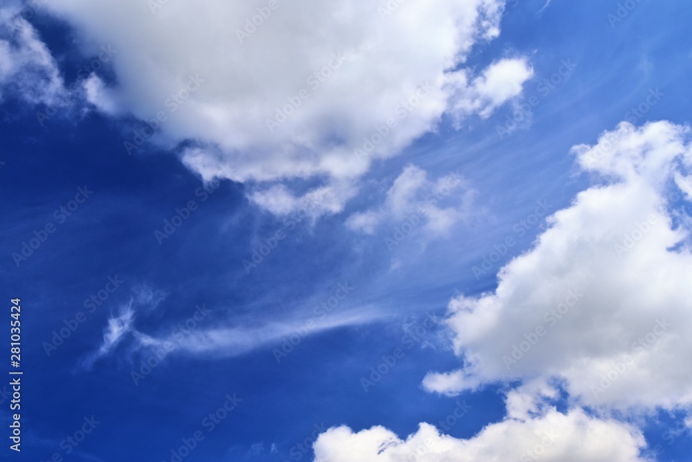 Beautiful white fluffy clouds on a deep blue summer sky