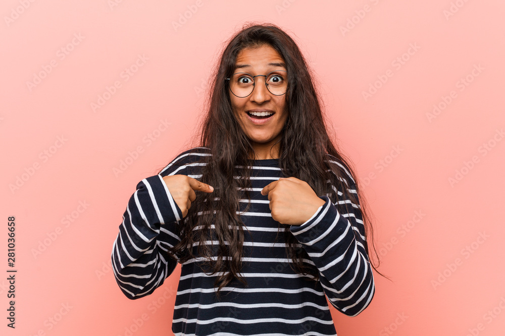 Young intellectual indian woman surprised pointing at himself, smiling broadly. Young intellectual indian woman surprised pointing at himself, smiling broadly.
