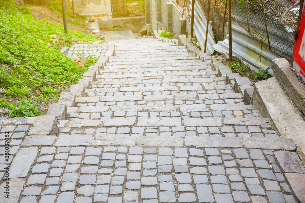 Stairs in the city. Narrow street with stone pavement. Stairs in the city. Narrow street with stone pavement.