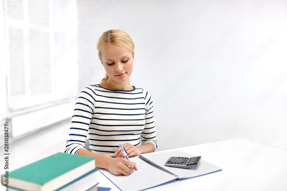 education, school and learning concept - student woman with books writing to notebook education, school and learning concept - student woman with books writing to notebook