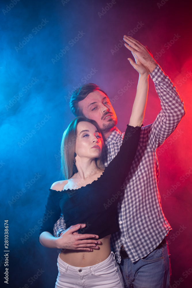 Social dance, kizomba, salsa, semba or zouk concept - a young couple dancing bachata and salsa at the disco Social dance, kizomba, salsa, semba or zouk concept - a young couple dancing bachata and salsa at the disco