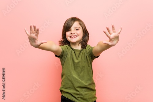 Little boy showing number ten with hands.