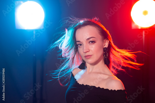 Portrait of young sexy woman with flashes on background