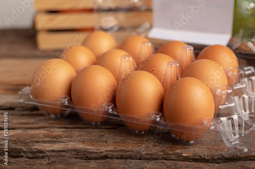 eggs of chicken in a plastic box placed on a wooden table