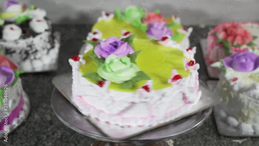 Decorated cake rotated on the cake plate. presentation in the pastry shop 4k Decorated cake rotated on the cake plate. presentation in the pastry shop 4k