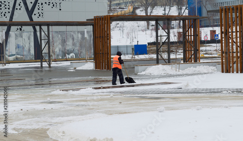 Wallpaper Mural Utility worker cleans snow shovel Torontodigital.ca