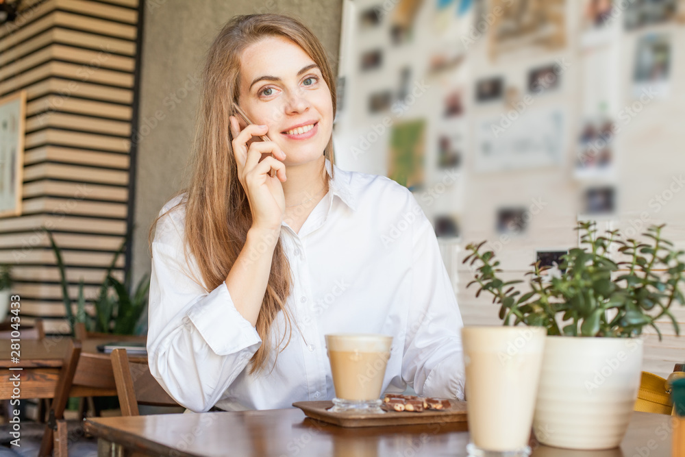 Business woman with smartphone working in open office place Business woman with smartphone working in open office place