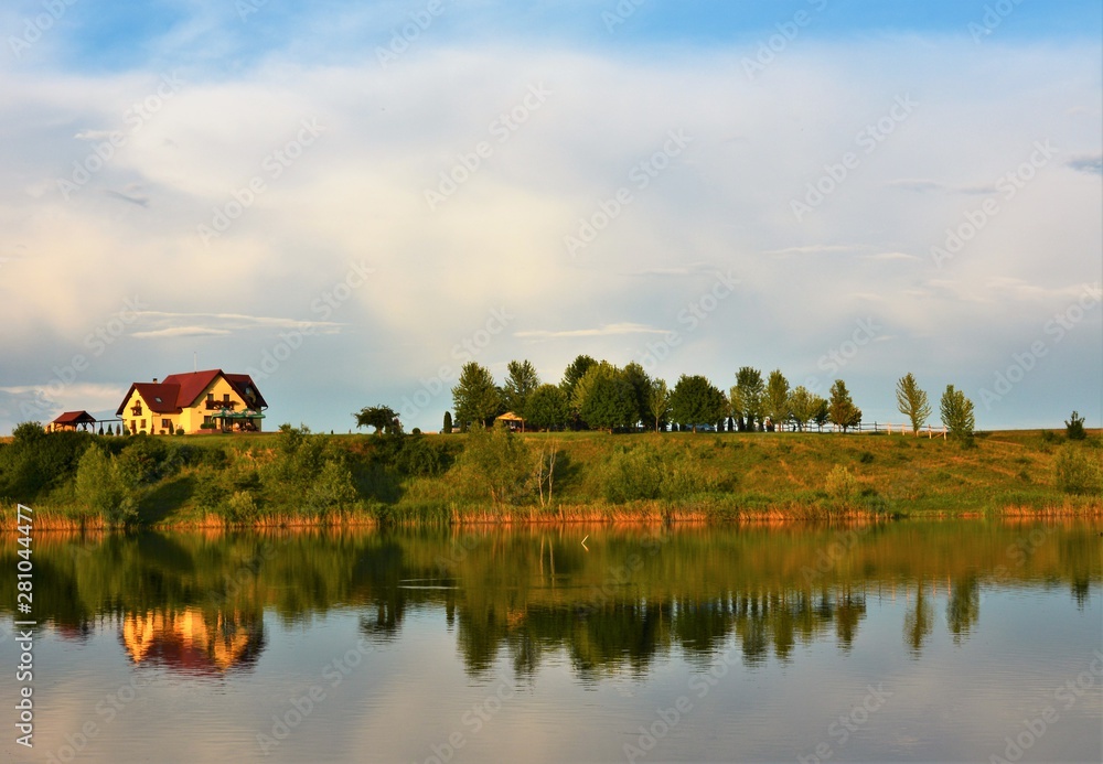 Fototapeta premium landscape with a house mirrored in the water