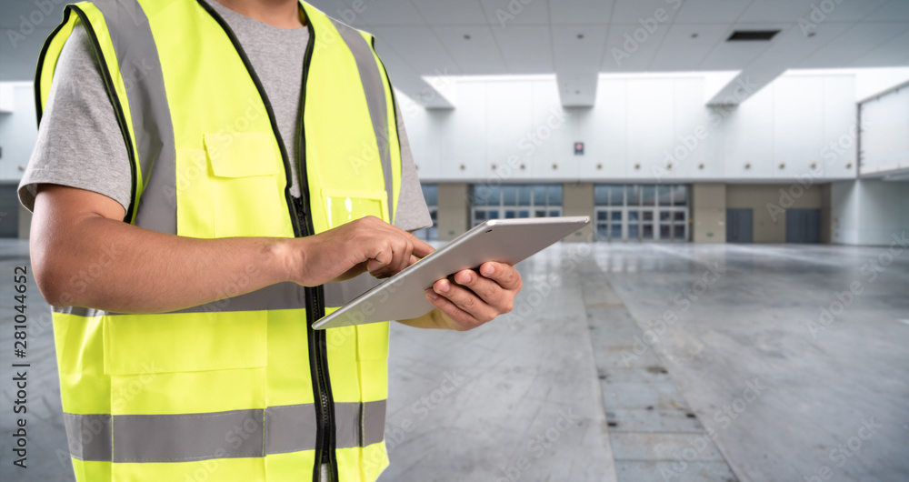 worker hand holding pad for check order pick time in empty warehouse worker hand holding pad for check order pick time in empty warehouse