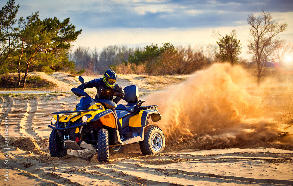 Racing powerful quad bike on the difficult sand in the summer. Racing powerful quad bike on the difficult sand in the summer.