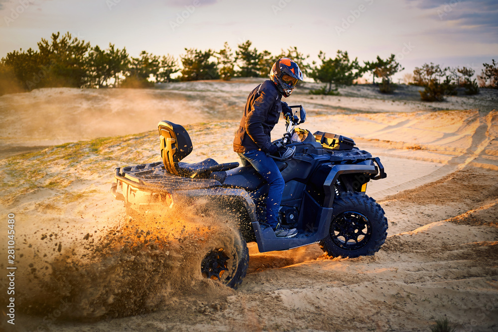 Racing powerful quad bike on the difficult sand in the summer. Racing powerful quad bike on the difficult sand in the summer.