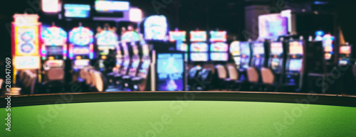 Slika na platnu Casino slot machines, green felt roulette table closeup view