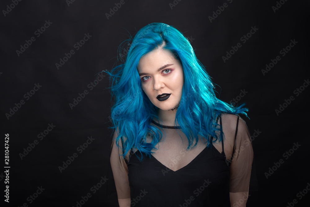 Fototapeta premium People, style and fashion concept - Close up portrait of young woman with blue long hair dressed in black dress
