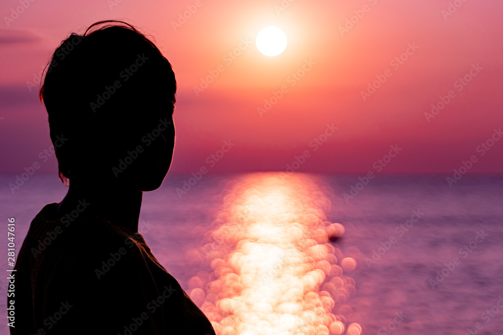 Girl in the background of the setting sun on the sea Girl in the background of the setting sun on the sea