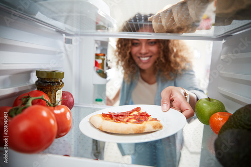Schilderij op canvas View Looking Out From Inside Of Refrigerator As Woman Opens Door For Leftover Ta