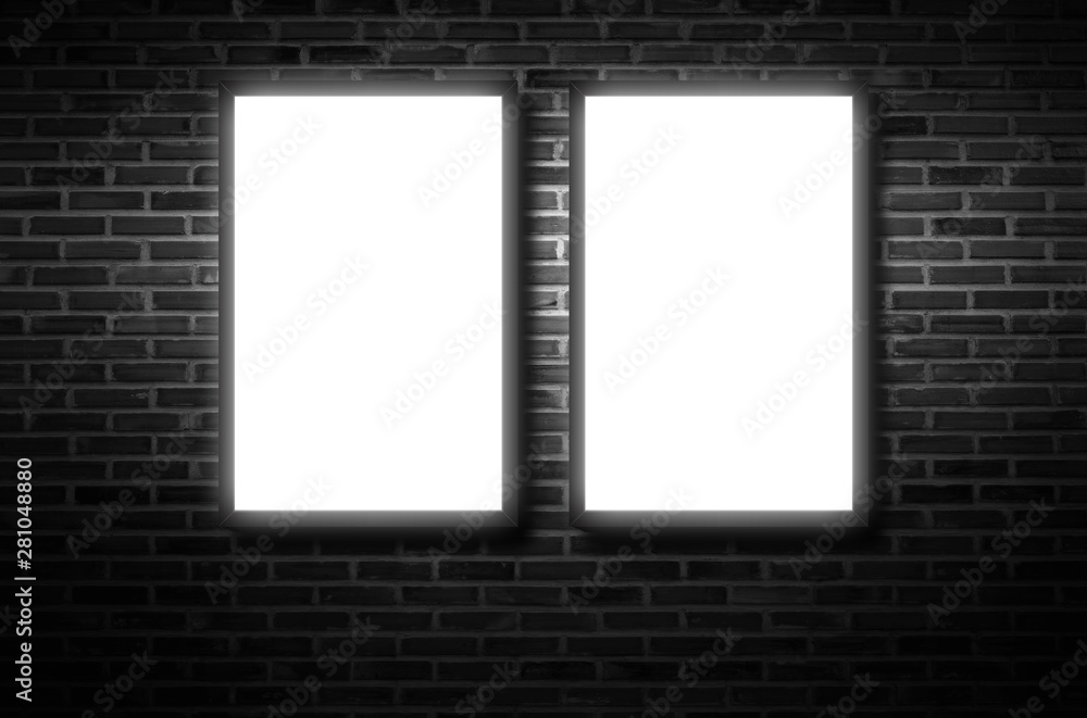 A white light box or billboard hanging on a black brick wall background in a night building A white light box or billboard hanging on a black brick wall background in a night building