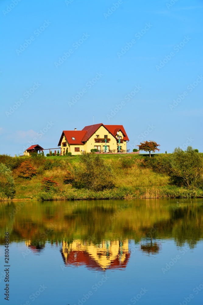 landscape with a house mirrored in the water landscape with a house mirrored in the water