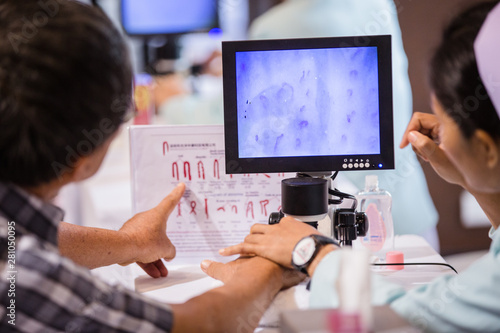 Nurses with fingerprint technology to patient.