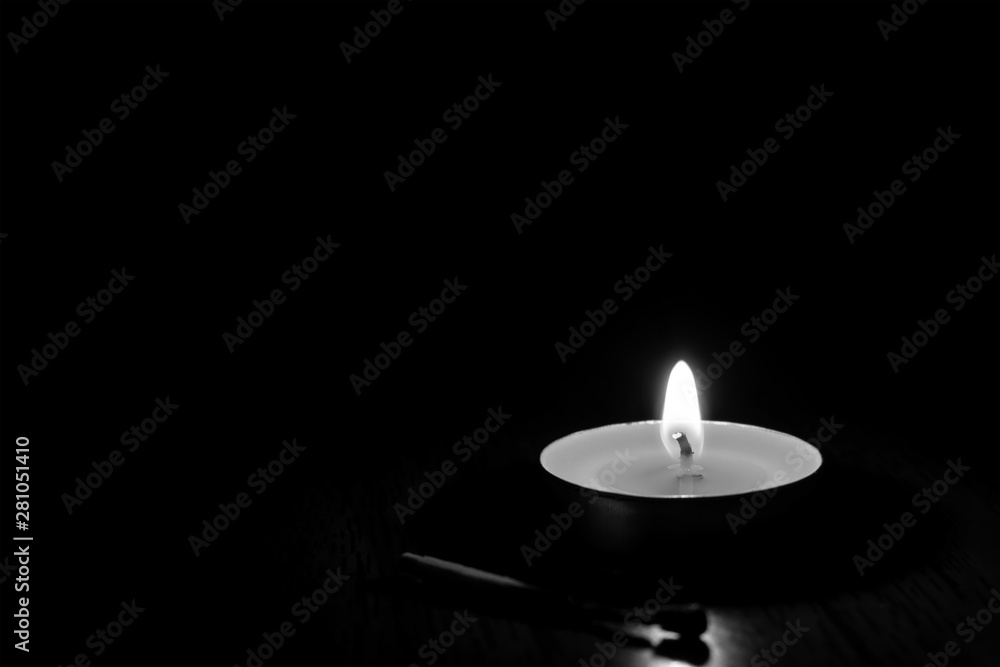 Candle burning in the black background. Candle burning in the black background.