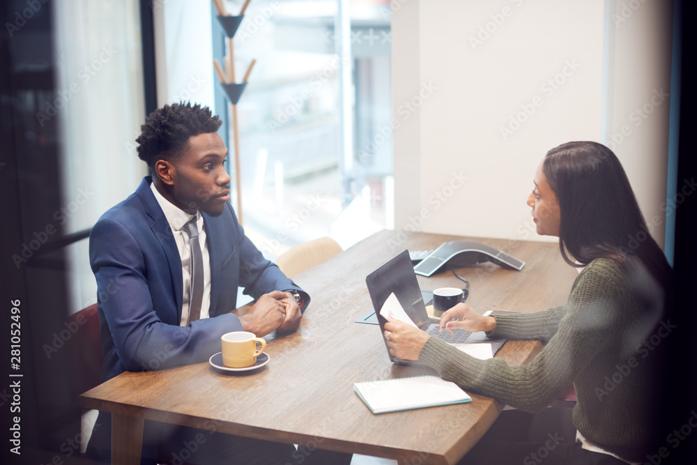 Businesswoman Interviewing Male Job Candidate In Meeting Room - obrazy, fototapety, plakaty 
