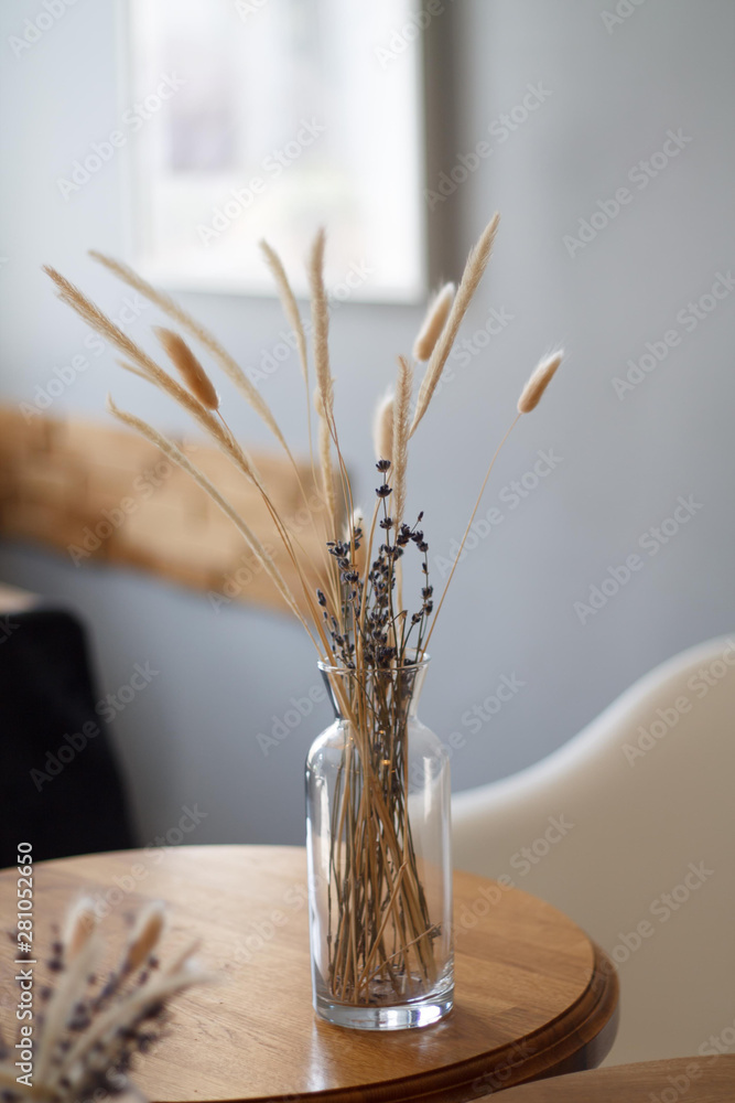 dried flowers in a vase on the background of the interior of the cafe