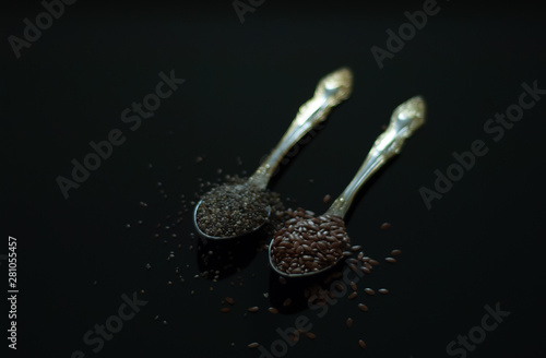 excellent image for the kitchen on a black background inseparable flaxseeds and chia seeds for healthy people