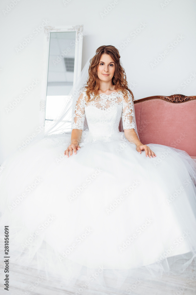 Beautiful bride in a wedding dress with lace, posing in the Studio Beautiful bride in a wedding dress with lace, posing in the Studio