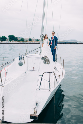 Wedding couple on the yacht, lovers posing on the yacht © Shopping King Louie