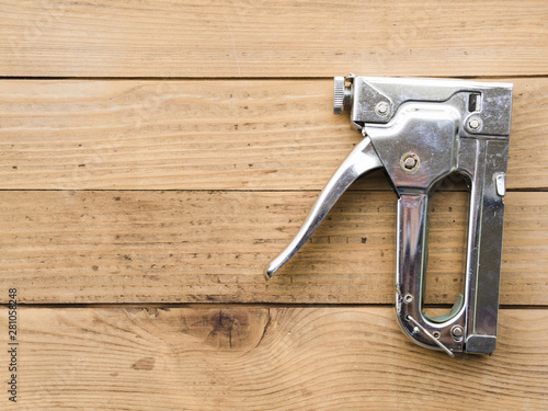 Steel staple gun on table