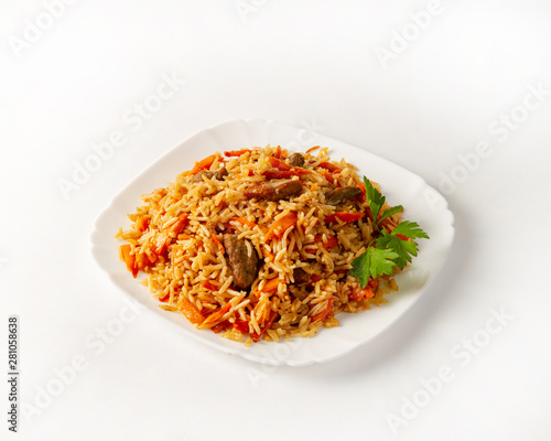 Portion of beef pilaf, decorated with parsley on white background