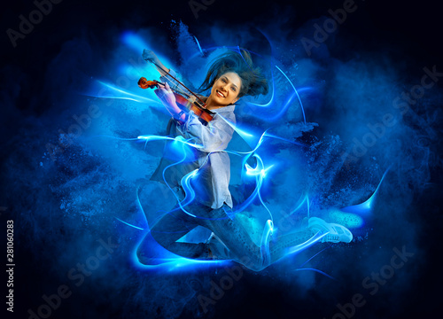 Woman playing violin on blue smoke background © Andrey Burmakin