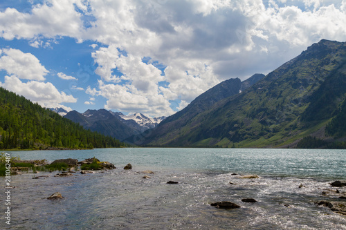 Multinsky lakes in Altai mountains. Picturesque landscape with clouds, trees and water. Summer sunny day.