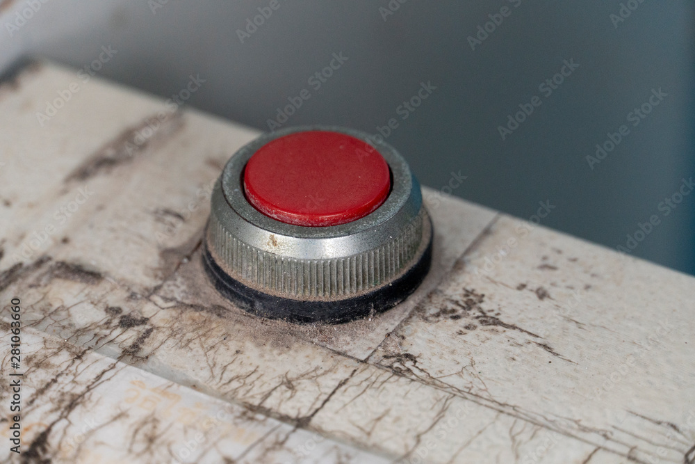 Old switch red button on white steel floor. Old switch red button on white steel floor.