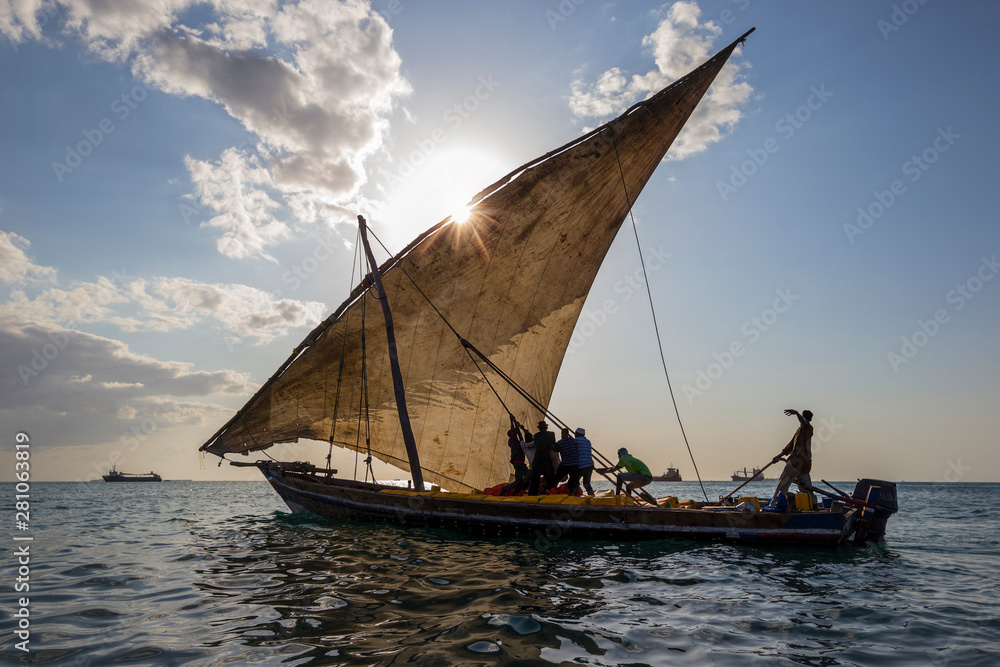 traditional dhow sailing boat setting sail for the open ocean and destination harbors