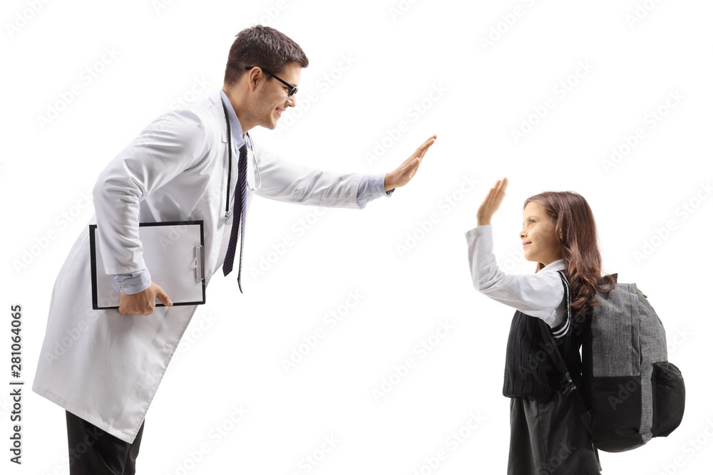 Young male doctor high-fiving with a schoolgirl Young male doctor high-fiving with a schoolgirl