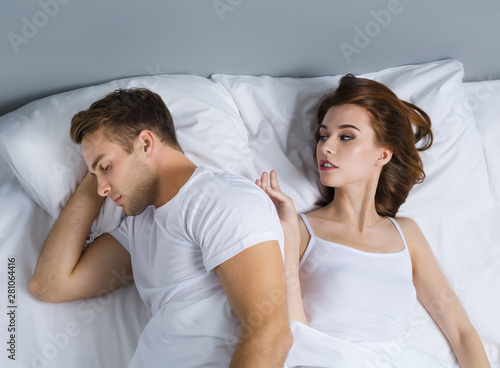 Unhappy young couple on the bed