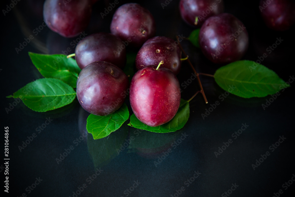 Fototapeta premium organic red ripe cherry plum isolated on black