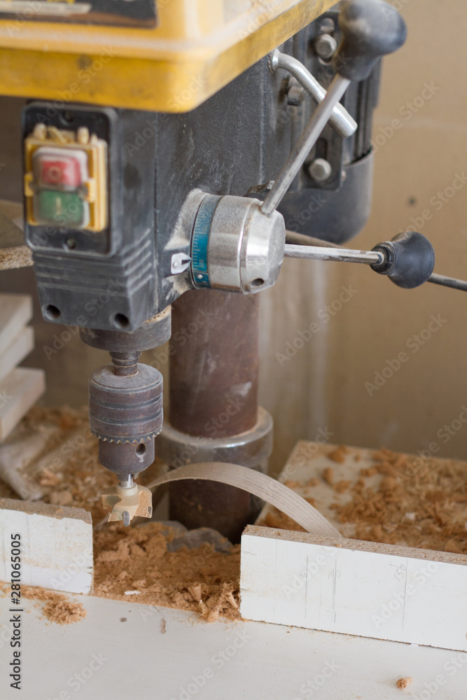 Boring machine with nozzle in the furniture workshop, selective focus Boring machine with nozzle in the furniture workshop, selective focus