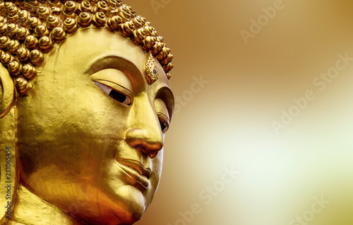Closeup Face of Statue big buddha in Asia Thailand. golden Colorful on yellow blur background photo