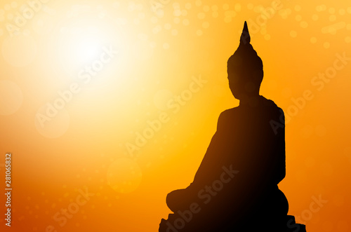 Silhouette buddha statues on blur sunset background. Concept buddha isolated on orange blurred background