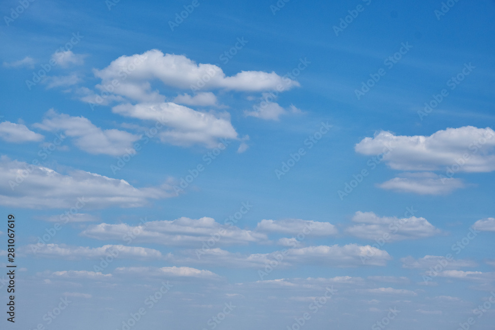 Background clouds on blue sky. White Cumulus clouds in clear weather. The sky on a Sunny summer day. Background clouds on blue sky. White Cumulus clouds in clear weather. The sky on a Sunny summer day.