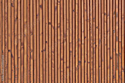 The texture of the surface of the wooden planks. Background of the ceiling cladding planks. Smooth boards with knots.