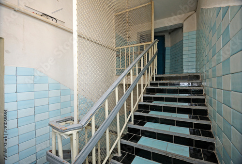 Part of prison hallway, bars, stairs, doors of the detention facility 