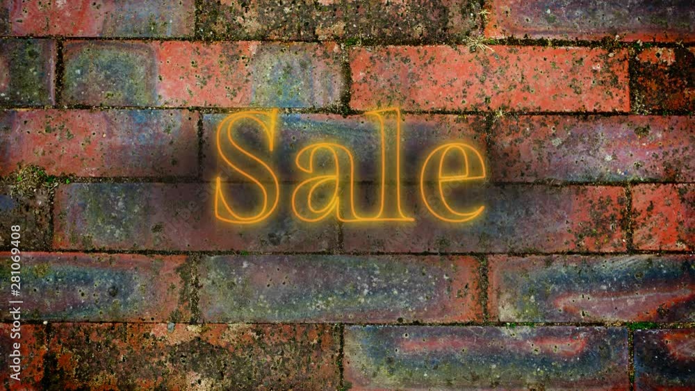 Yellow neon sale sign on brick wall