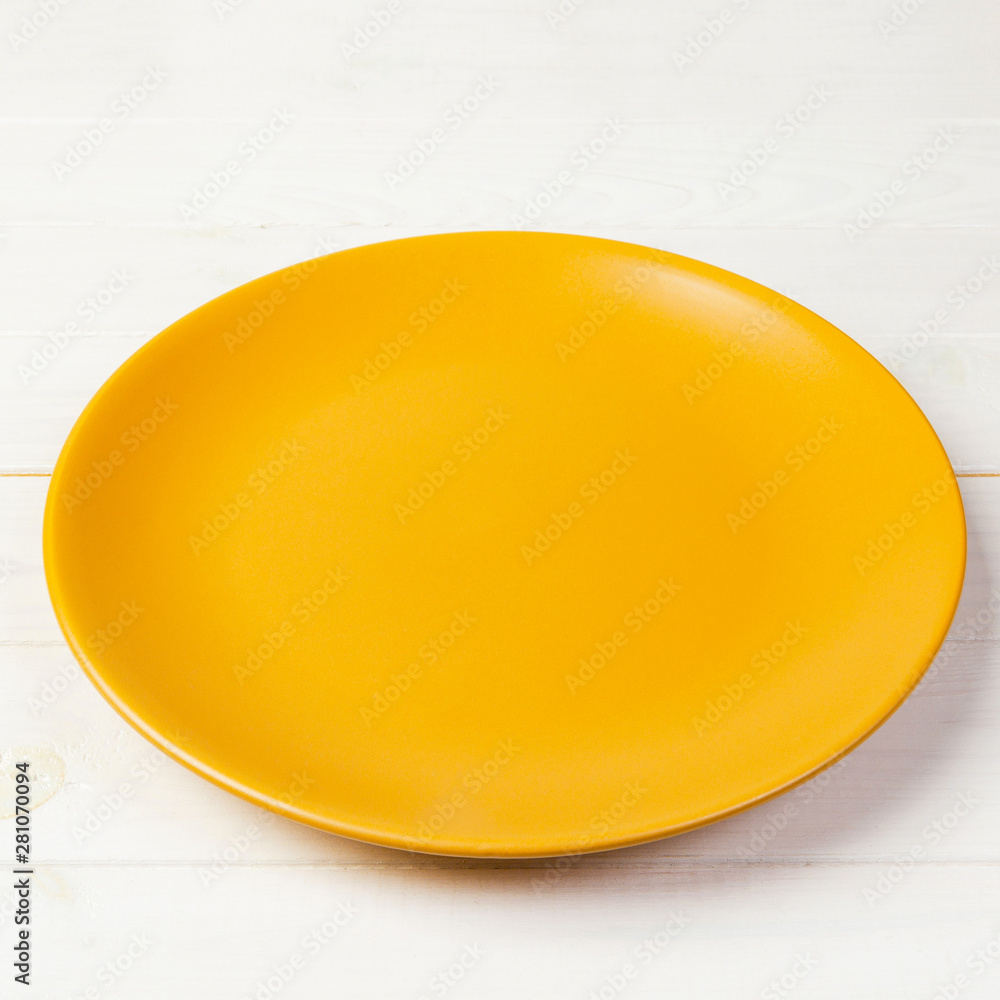 Yellow Round Plate on wooden table background. Top view, template for your design Yellow Round Plate on wooden table background. Top view, template for your design