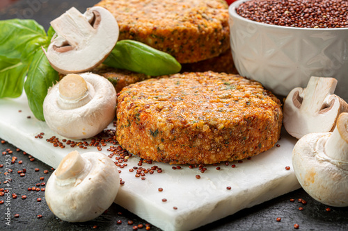 Tasty vegetarian and vegan burgers made from healthy quinoa, basil, tomatoes and champignon mushrooms photo