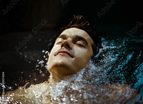 Portrait of young man in hot tub  photo