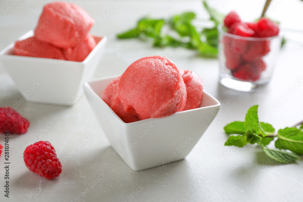 Delicious pink ice cream in bowl on grey table Delicious pink ice cream in bowl on grey table